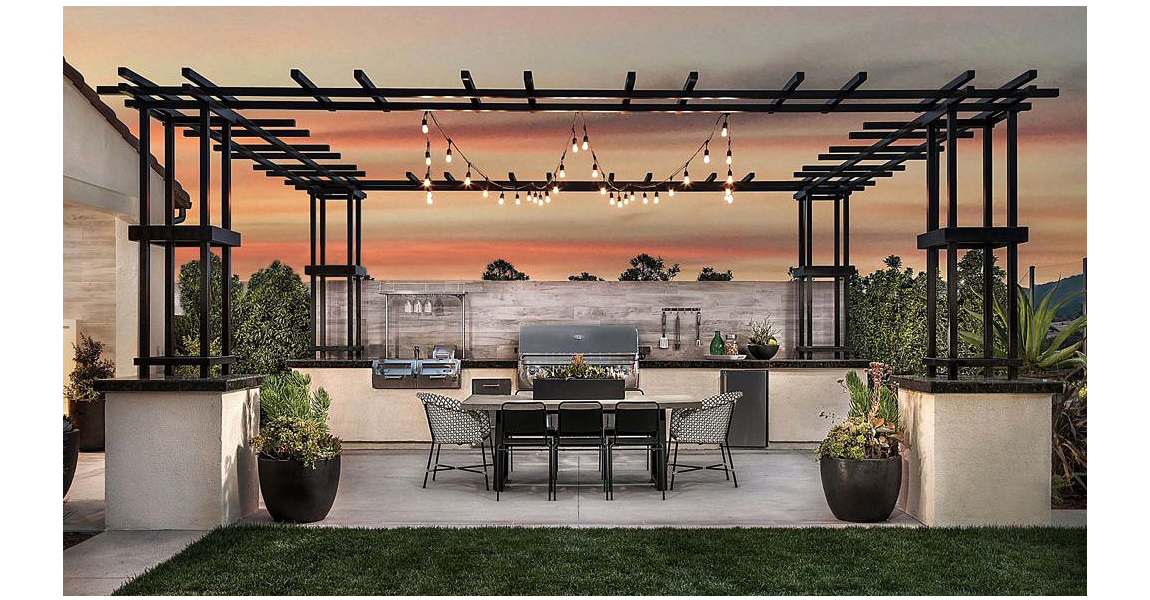 Outdoor kitchen with pergola, table and light